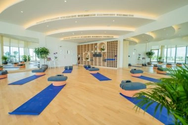 Yoga studio inside the 321 Sports Club on Hudayriyat Island in Abu Dhabi, featuring natural light, wooden floors, and a serene atmosphere.