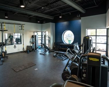 Modern fitness room fully equipped with machines and training equipment at Mouratoglou Academy Zephyrhills.