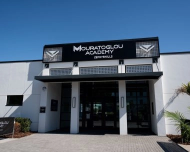 Front entrance of Mouratoglou Academy Zephyrhills in Florida, showing campus access and signage.