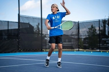 Young tennis player practicing a forehand at the Mouratoglou Academy