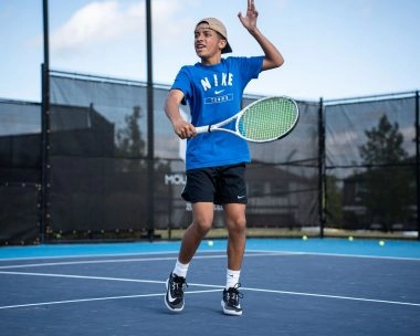 Young tennis player practicing a forehand at the Mouratoglou Academy