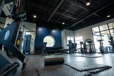 Modern fitness room with state-of-the-art machines and training equipment at Mouratoglou Academy Zephyrhills.