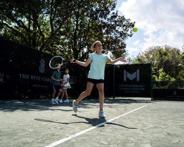 Kid playing tennis on the courts of Mouratoglou Tennis Center Amelia Island