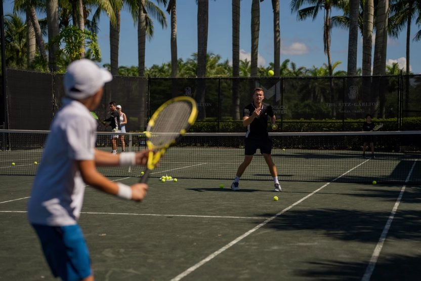 Young tennis player training with a coach at Mouratoglou Tennis Center Naples, Florida