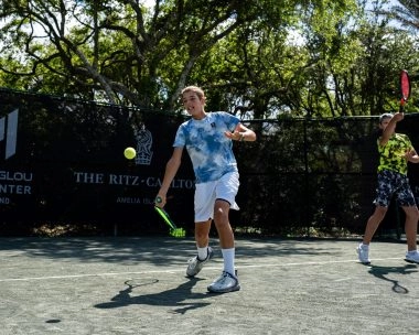 Child receiving a tennis ball on the courts of Mouratoglou Tennis Center Amelia Island