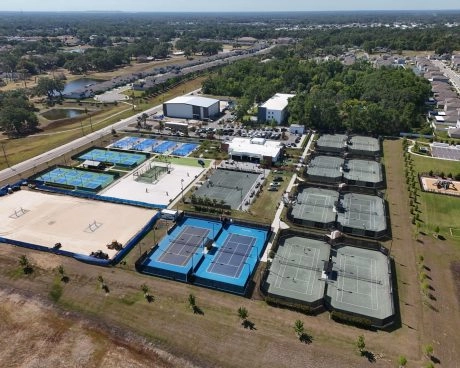 Aerial drone view of tennis courts, pickleball courts, and sports facilities at Mouratoglou Academy Zephyrhills in Florida.
