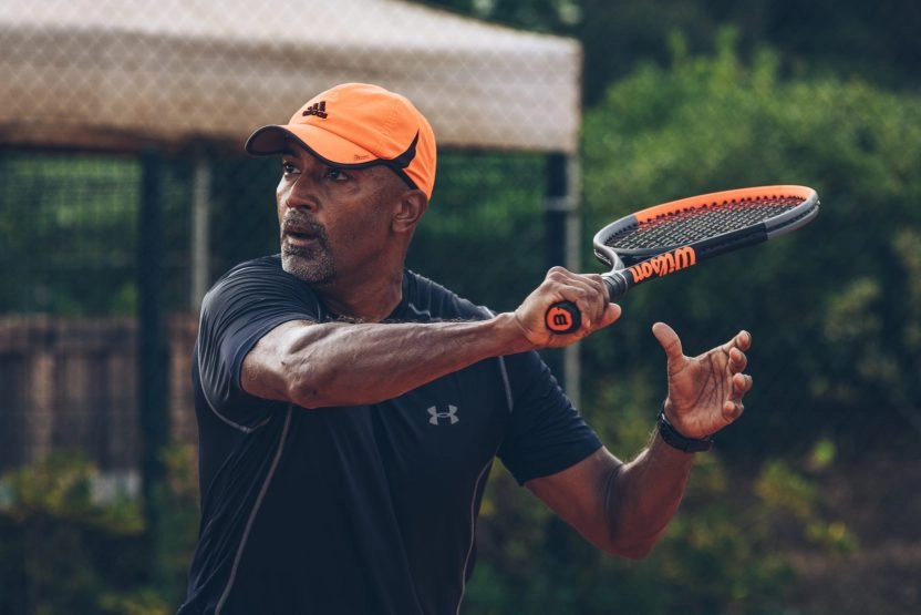 Tennis coach preparing a forehand during an action drill