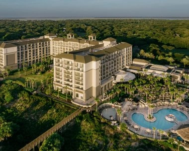 Aerial view of the Ritz-Carlton Amelia Island resort and oceanfront pool overlooking the Atlantic Ocean.