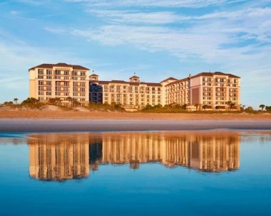 An elegant ocean-view room at The Ritz-Carlton Amelia Island, offering refined comfort and breathtaking views of the Atlantic. This image reflects the serenity and sophistication that surround the Mouratoglou Tennis Center experience — where luxury and relaxation meet coastal beauty.