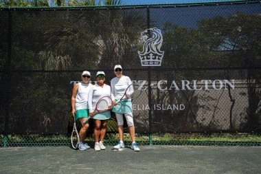 Group photo in front of the Mouratoglou Tennis Center windbreakers at Amelia Island