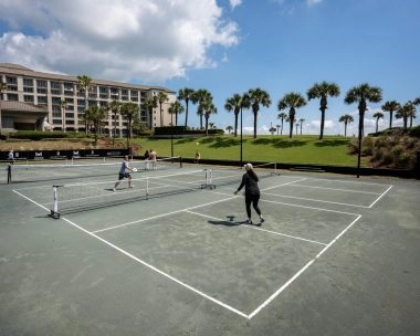 Players enjoying a pickleball match at the Ritz-Carlton Amelia Island resort courts.