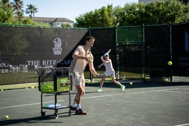 Coach training children on the courts of Mouratoglou Tennis Center Amelia Island