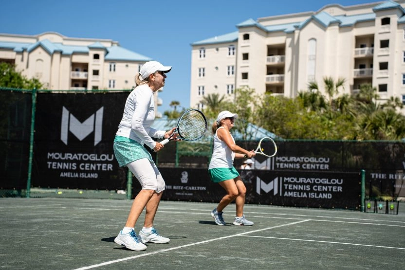 Two women playing tennis during a clinic at Mouratoglou Tennis Center Amelia Island