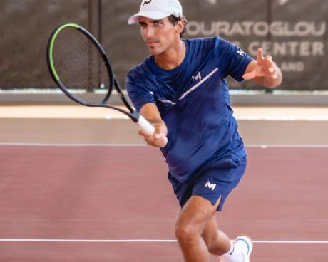 Coach Jaime playing on the courts of Mouratoglou Tennis Center Hudayriyat Island in Abu Dhabi, demonstrating power and precision during a training session.