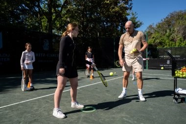 Coach training a child on the courts of Mouratoglou Tennis Center Amelia Island
