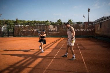 A coach providing private lesson to a player