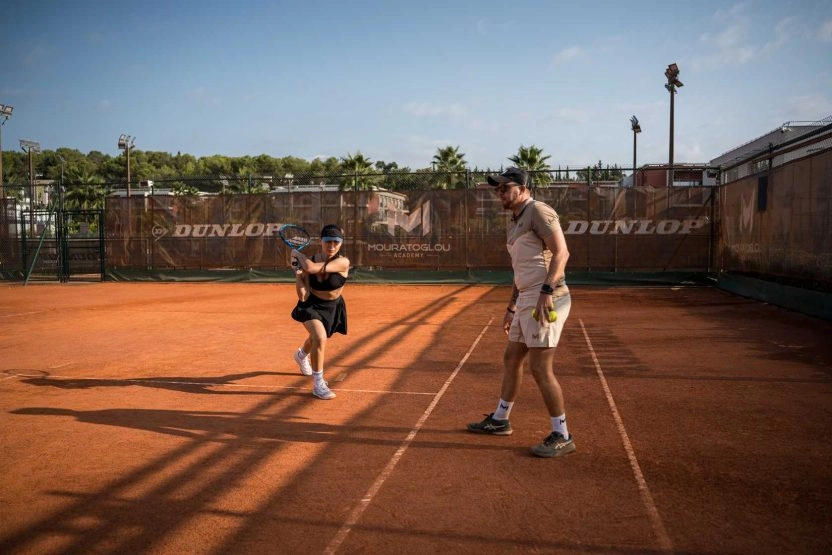 A coach providing private lesson to a player