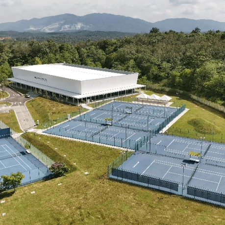 Aerial view of the Mouratoglou Tennis Academy Malaysia with multiple outdoor blue courts