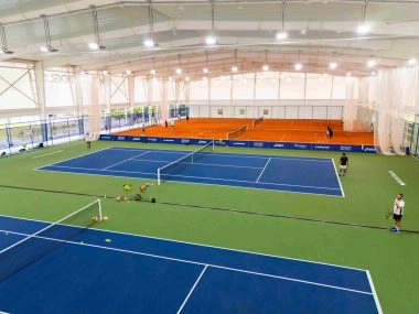 Indoor tennis facility with blue and clay courts at Mouratoglou Tennis Programme Malaysia