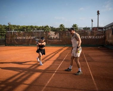 A coach providing private lesson to a player