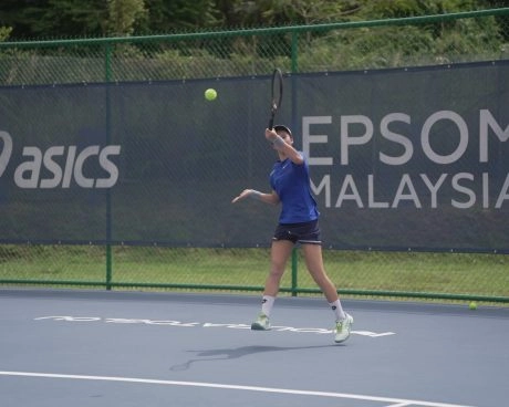 Player hitting a forehand on an outdoor court at Epsom Malaysia