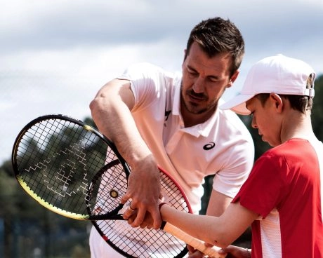 Coach teaching racket handling