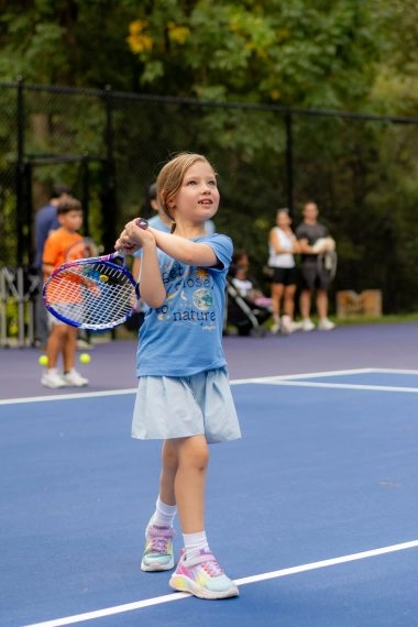 Young tennis player training with her coach on court at Mouratoglou Academy Atlanta