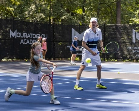 Young tennis player training on court with Andreas Seppi at Mouratoglou Academy Atlanta
