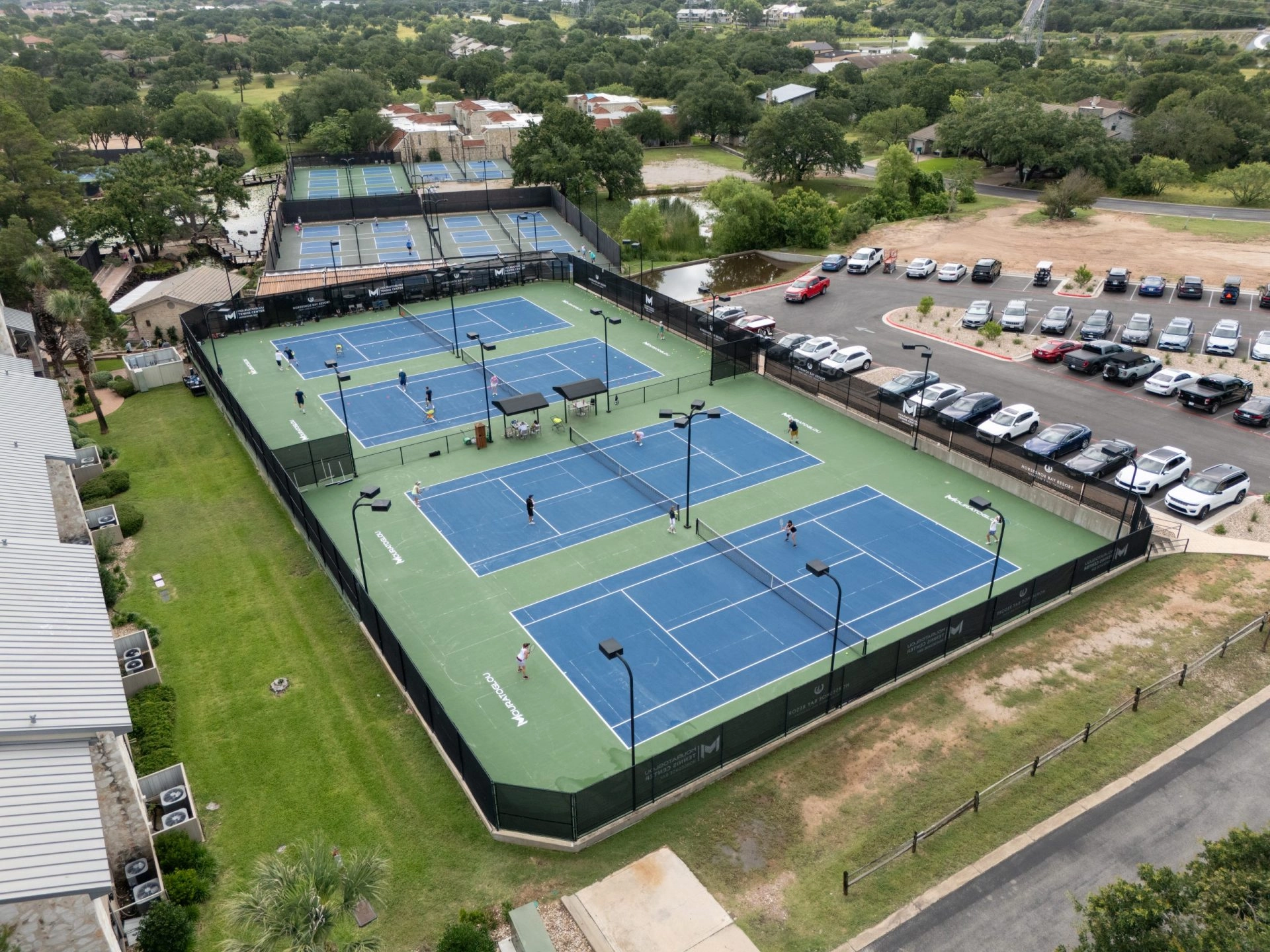 Outdoor tennis courts at Mouratoglou Tennis Center Horseshoe Bay in Texas Hill Country.