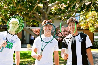 Three boys holding tennis racquets outdoors at Mouratoglou Academy San Francisco.