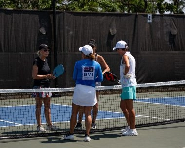 Four players at the net during a pickleball game at Mouratoglou Tennis Center Horseshoe Bay.