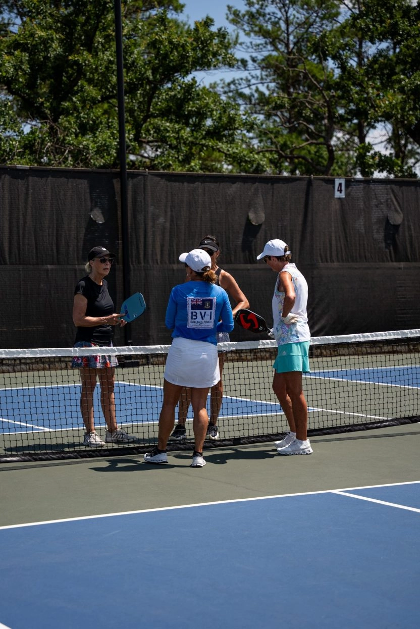 Four players at the net during a pickleball game at Mouratoglou Tennis Center Horseshoe Bay.
