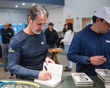 Patrick Mouratoglou signing his book during a special event at Mouratoglou Tennis Center Boston in Massachusetts