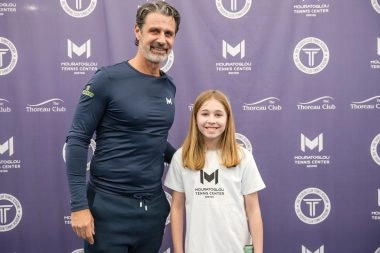 Patrick Mouratoglou posing with young player at Mouratoglou Tennis Center Boston