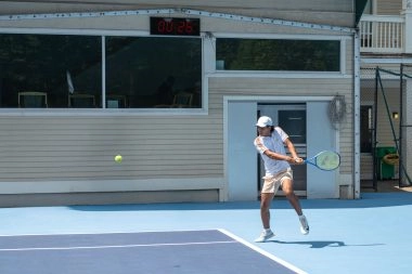 Tennis player competing on court at Mouratoglou Tennis Center Boston, Massachusetts
