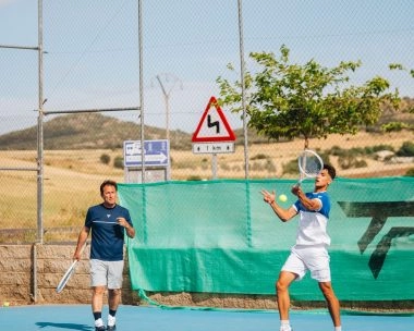 Tennis players in rally on a blue hard court at Mouratoglou Tennis Center Calatrava