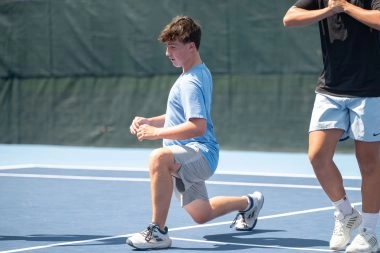 Junior tennis player stretching on court during training at Mouratoglou Tennis Center Boston