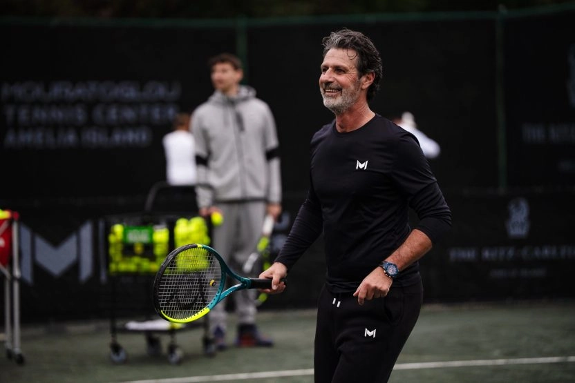 Patrick Mouratoglou playing tennis on the courts at Mouratoglou Tennis Center Amelia Island.