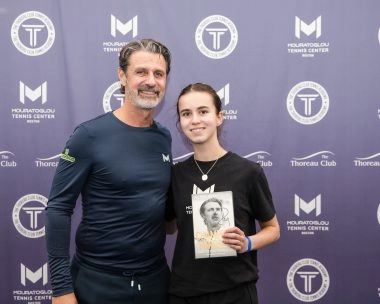 Female tennis player posing with Patrick Mouratoglou at Mouratoglou Tennis Center Boston, Massachusetts