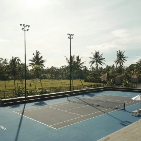 Outdoor tennis court surrounded by tropical landscape at Mouratoglou Tennis Center Bali.