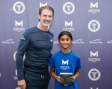Patrick Mouratoglou posing with a young player at Mouratoglou Tennis Center Boston Description: