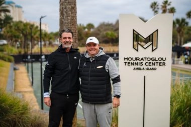 Patrick Mouratoglou and Head Coach Rob Lehner posing in front of the Mouratoglou totem at Amelia Island.