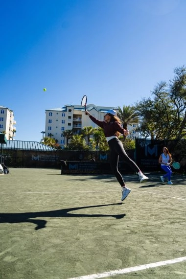 Female tennis player receiving a ball during a rally at Mouratoglou Tennis Center Amelia Island.