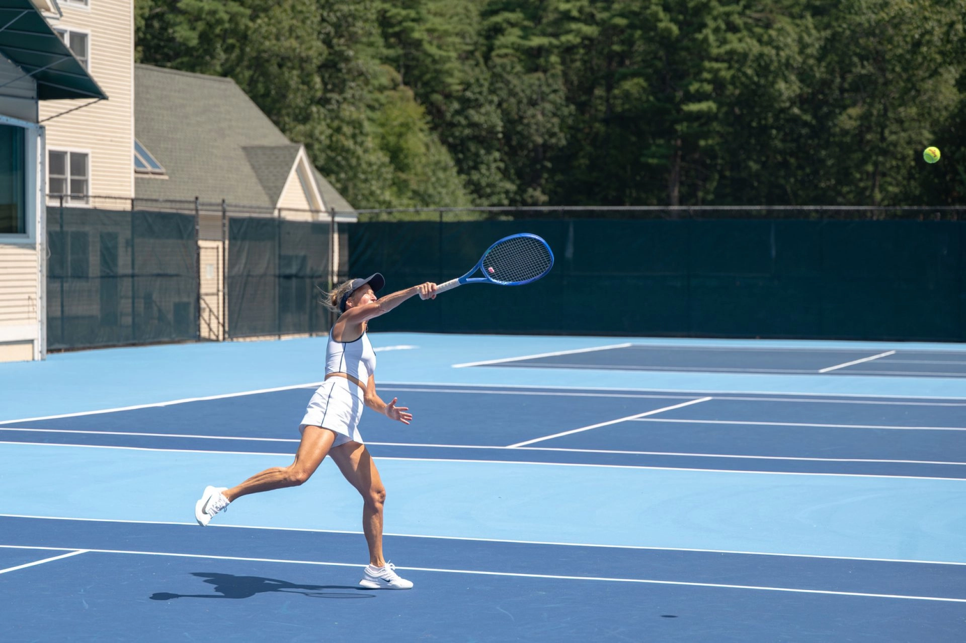 Adult female tennis player in action at Mouratoglou Tennis Center Boston, Massachusetts