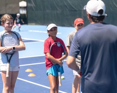 Children listening to their coach at Mouratoglou Tennis Center Boston Description: