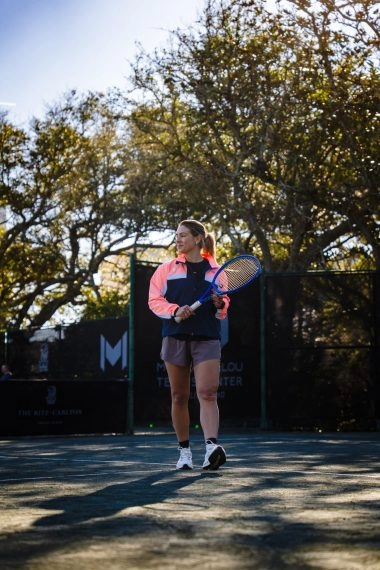 Female tennis player walking on the court at Mouratoglou Tennis Center Amelia Island.