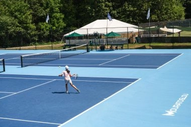 Adult tennis player training on court at Mouratoglou Tennis Center Boston, Massachusetts