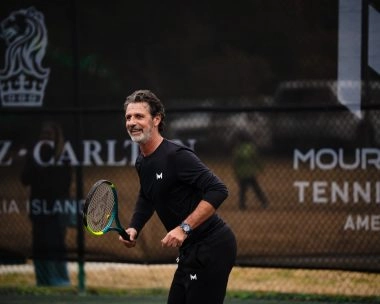 Patrick Mouratoglou playing on the tennis court at Mouratoglou Tennis Center Amelia Island.