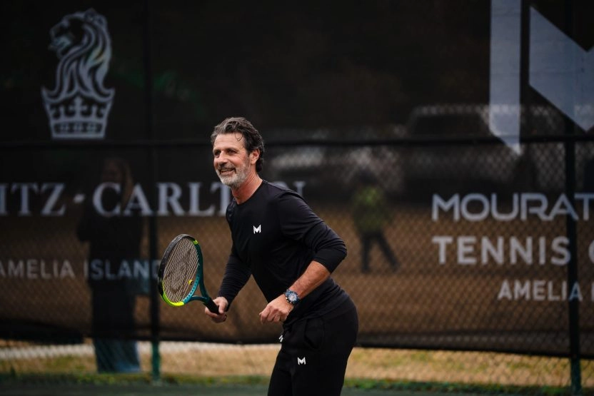 Patrick Mouratoglou playing on the tennis court at Mouratoglou Tennis Center Amelia Island.