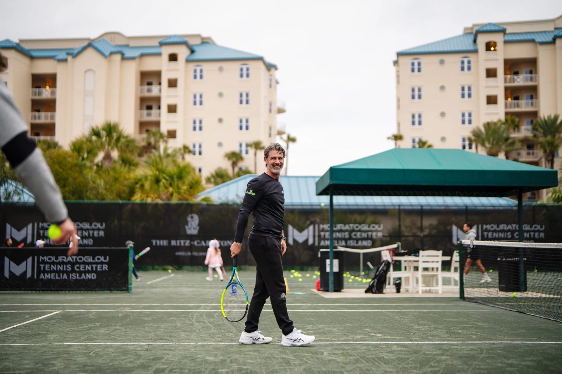 Patrick Mouratoglou walking across the tennis court at Mouratoglou Tennis Center Amelia Island.